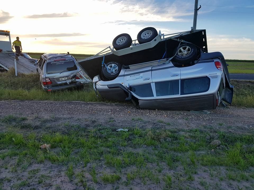 A Car is Upside Down on the Side of the Road — Hervey Bay Tilt Tray Hire In Takura, QLD
