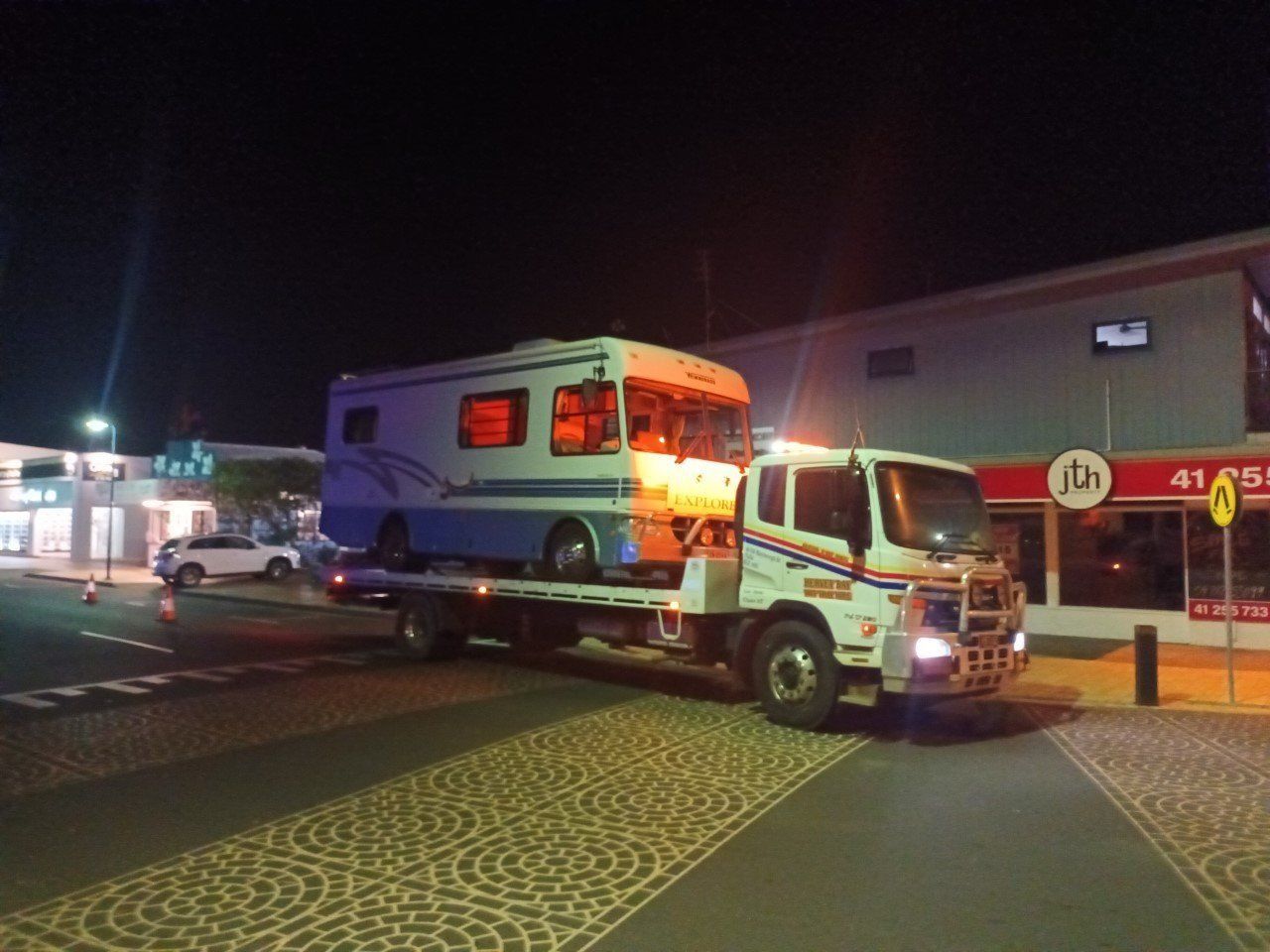 A Rv is Being Towed by a Tow Truck — Hervey Bay Tilt Tray Hire In Takura, QLD