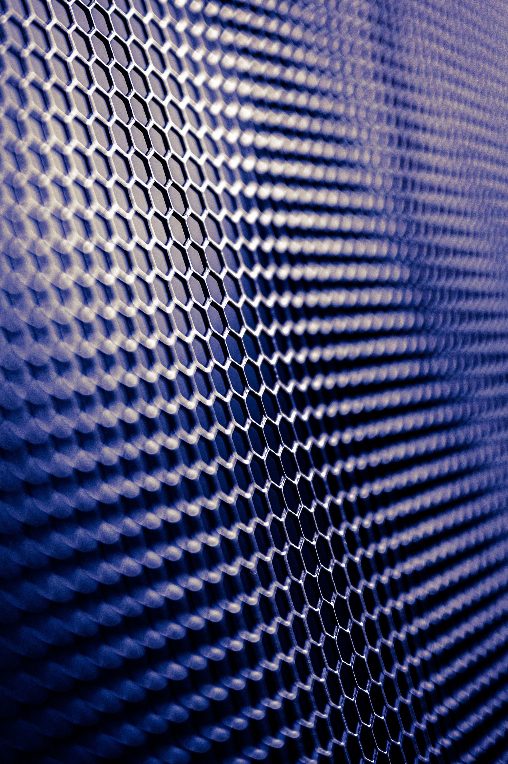Close-up of a blue and purple textured mesh pattern with diagonal ridges and highlights