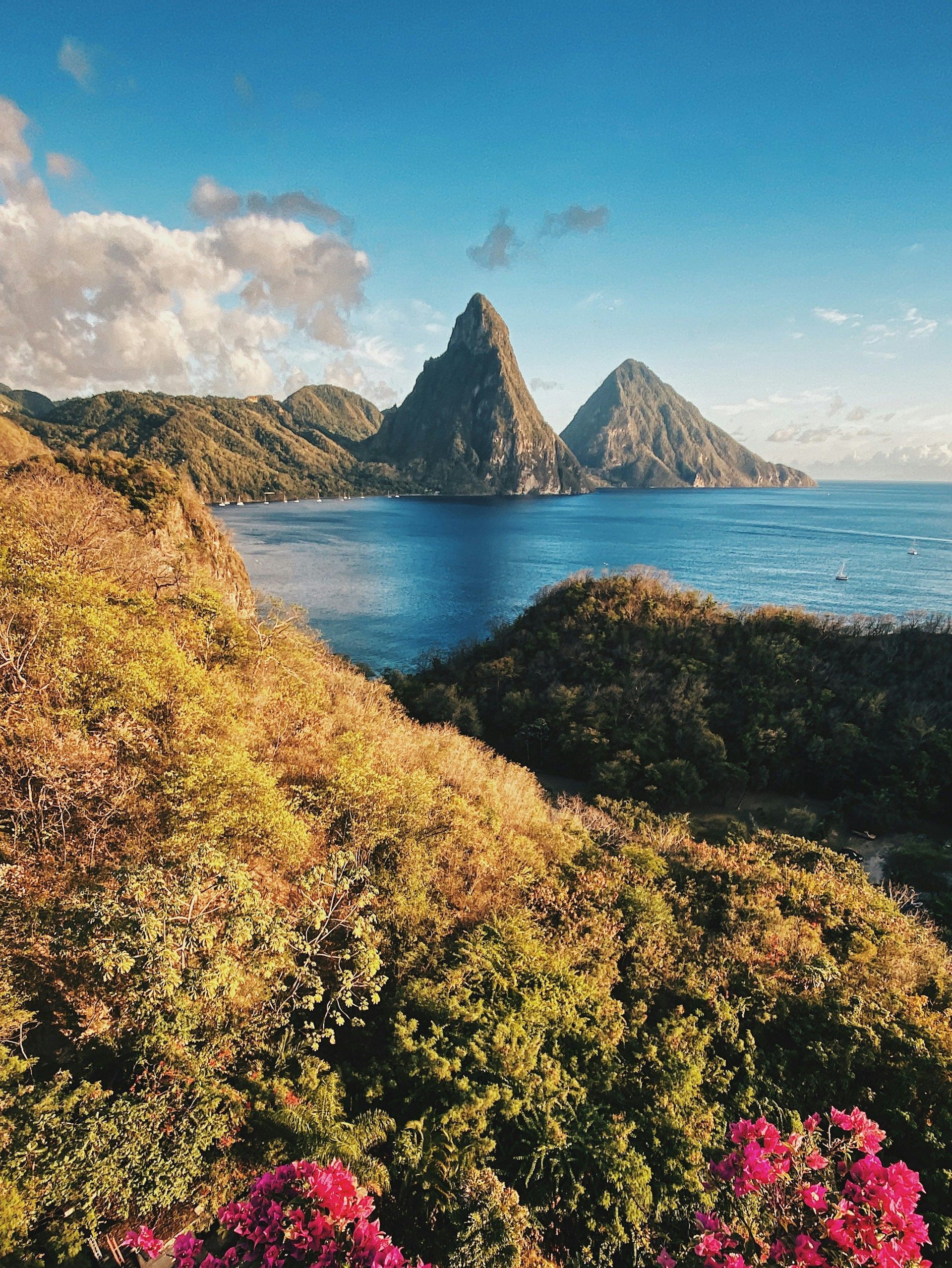 There are two mountains in the background and a body of water in the foreground.