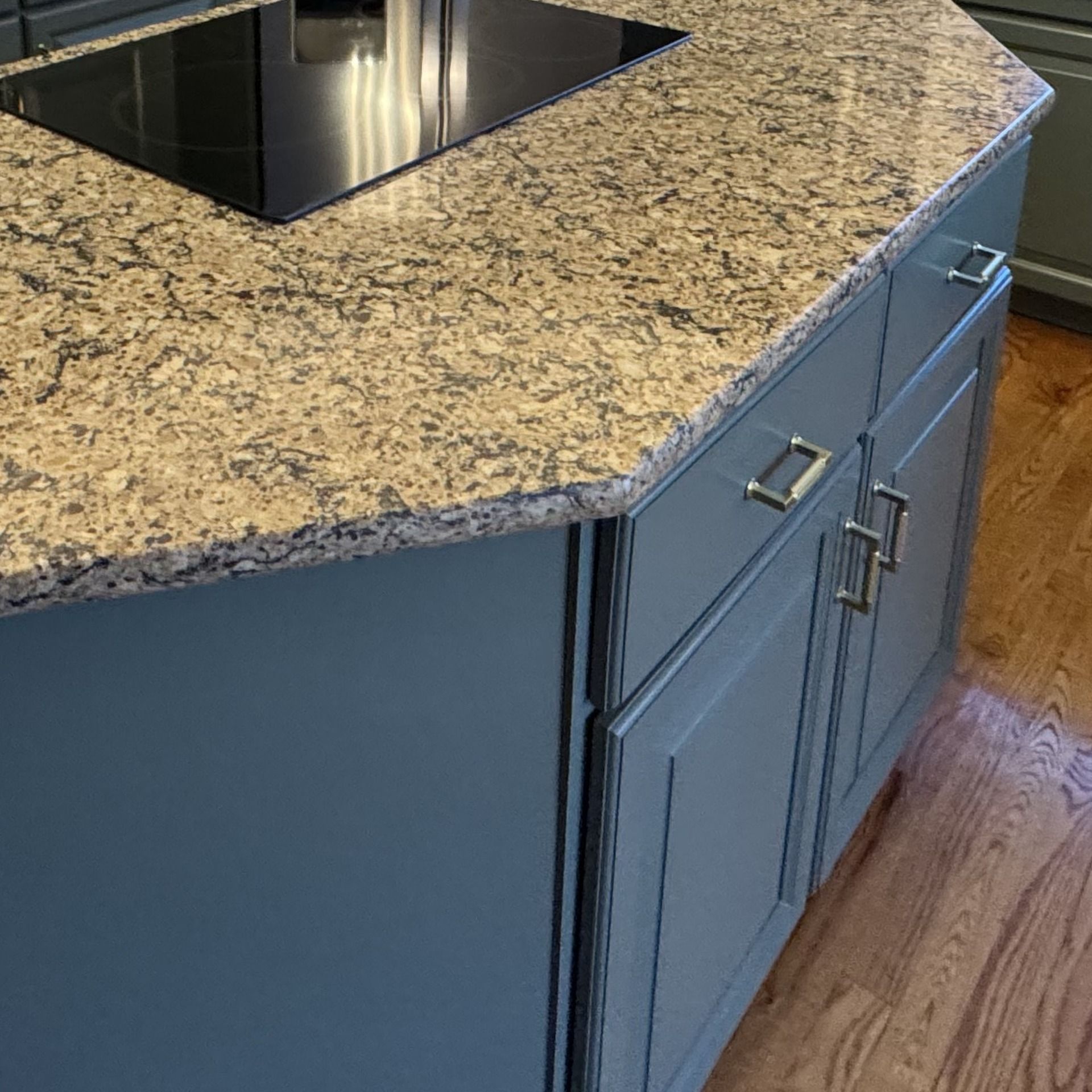 Painted kitchen island cabinets with a stone countertop
