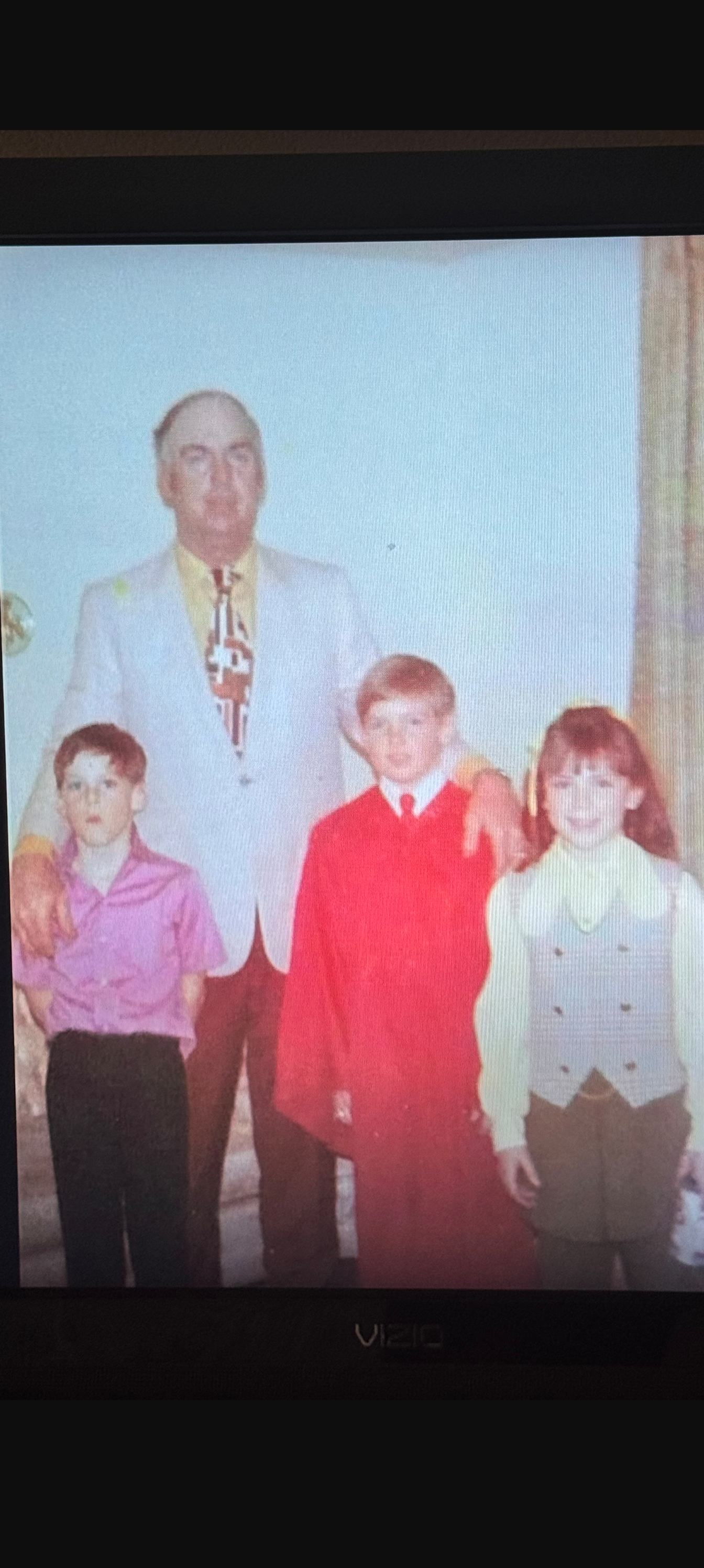 An archival photograph supplied by the Carroll family, showing an adult with three children