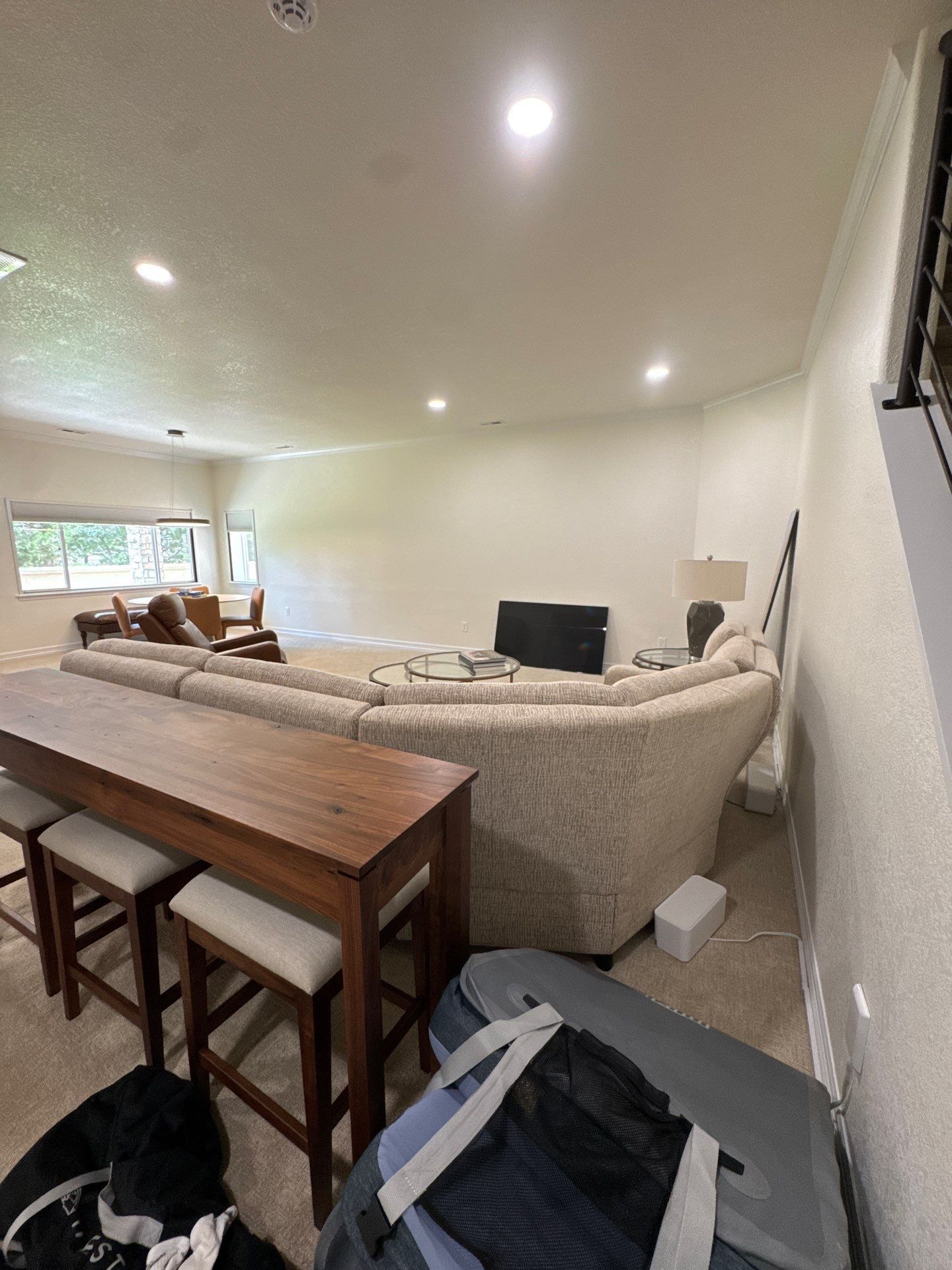 Basement living area with seating and connected walls in the same Carroll painting estimate