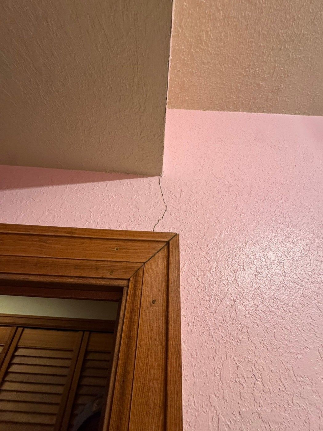 Painted bathroom wall meeting wood trim in the same Colorado Springs project record