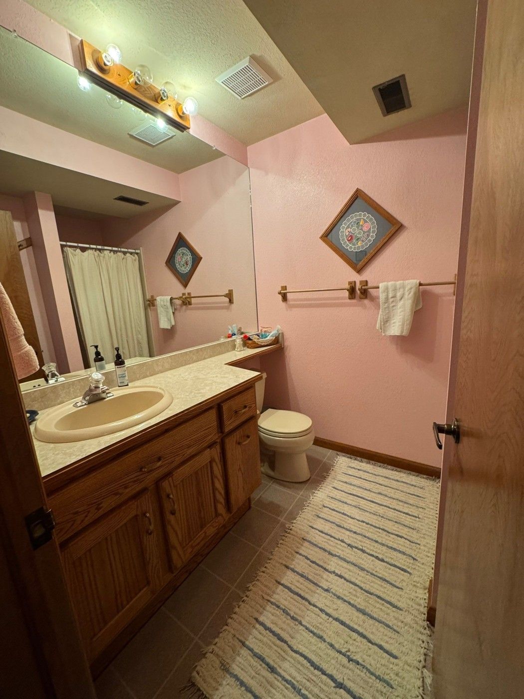 Bathroom wall and ceiling context with retained wood vanity and trim in Colorado Springs