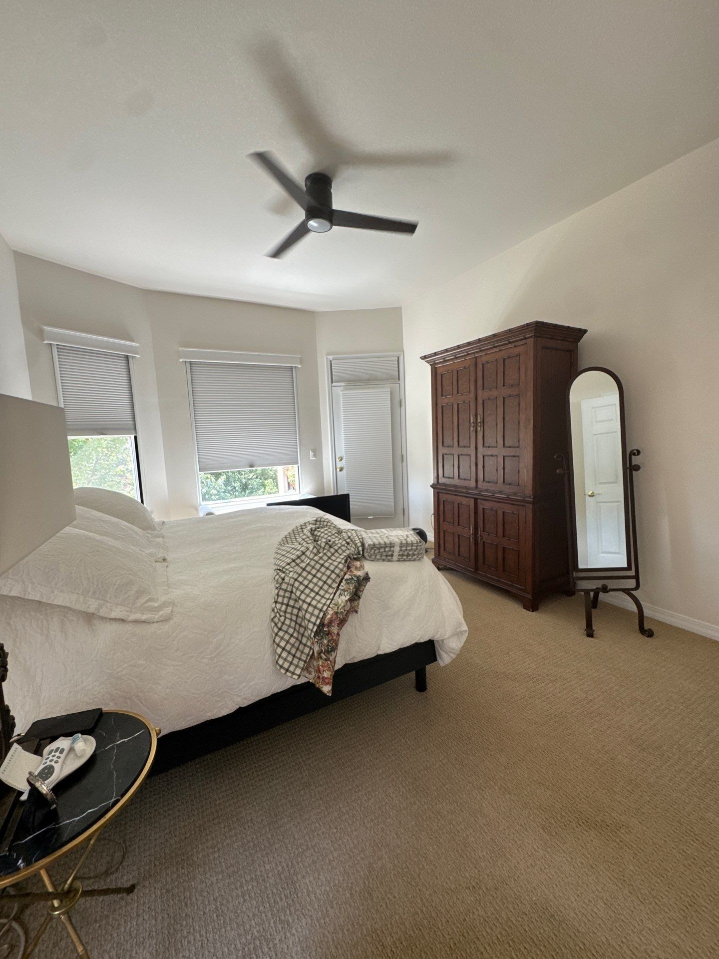 Furnished primary bedroom with carpet and windows in a Carroll two-area interior project record