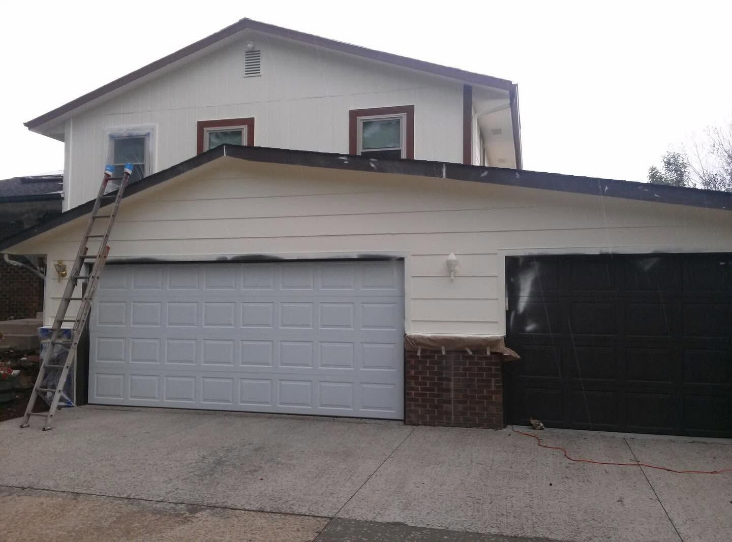 Garage exterior before completion of Carroll Painting white siding and brown trim project
