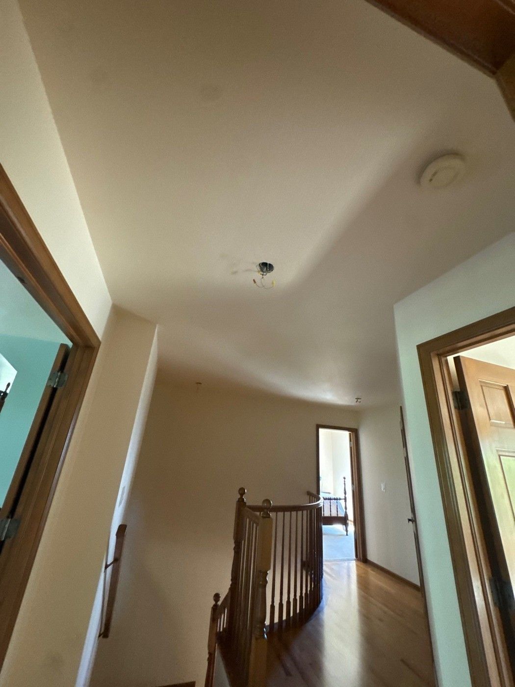 Stairwell ceiling, landing and railing photographed during planning in Colorado Springs