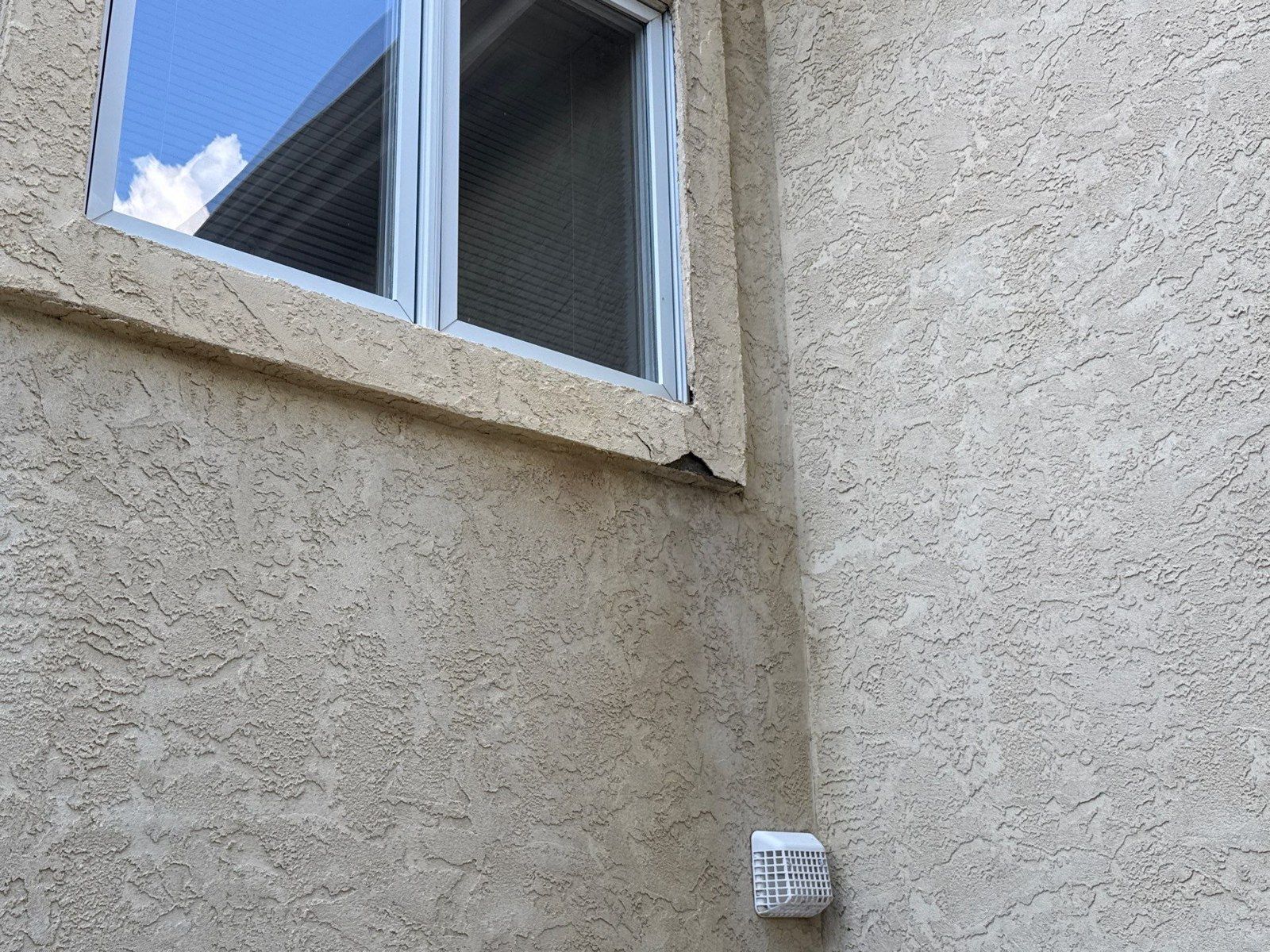 Textured stucco wall and projecting window surround at the Colorado Springs project