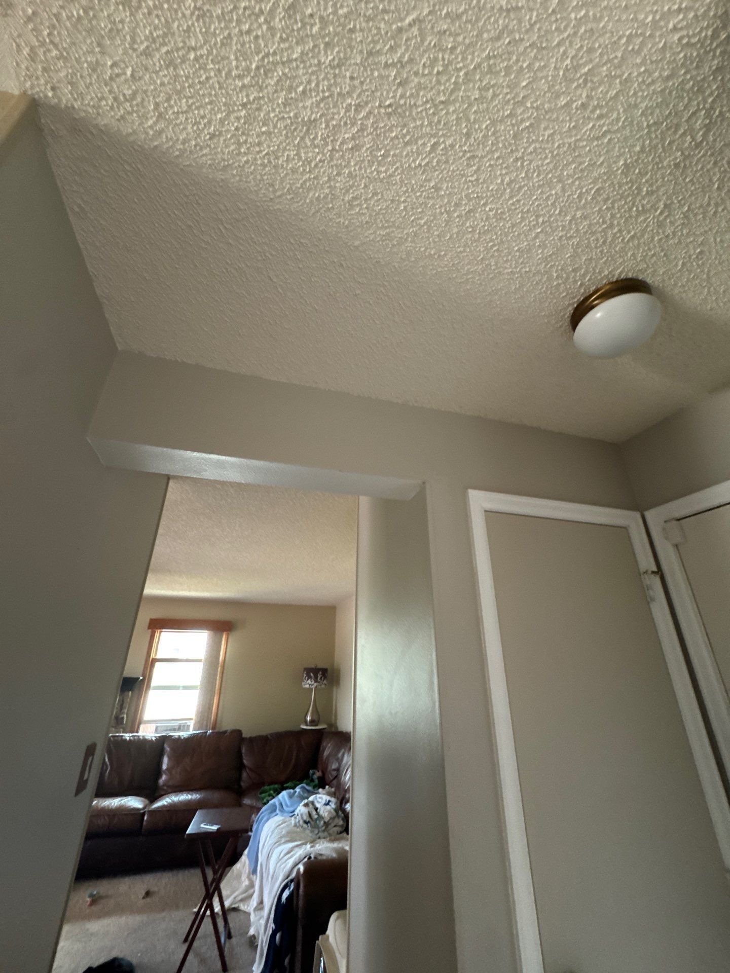 Existing textured ceiling and hallway at the Colorado Springs home in this interior preparation estimate