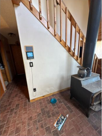 Wall beside a staircase, stove and retained wood finishes in an Elbert painting estimate