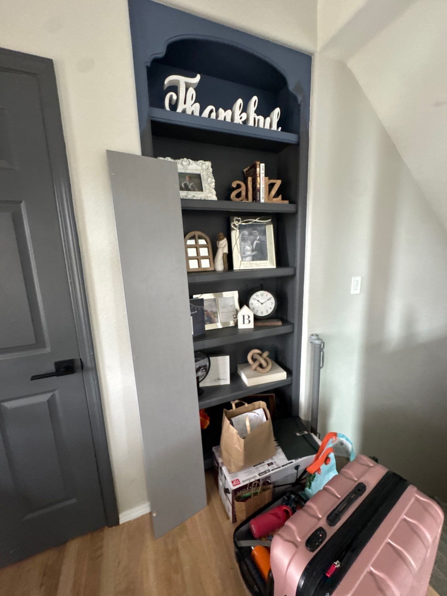 Entry bookshelf beside a dark painted door in the same Colorado Springs estimate