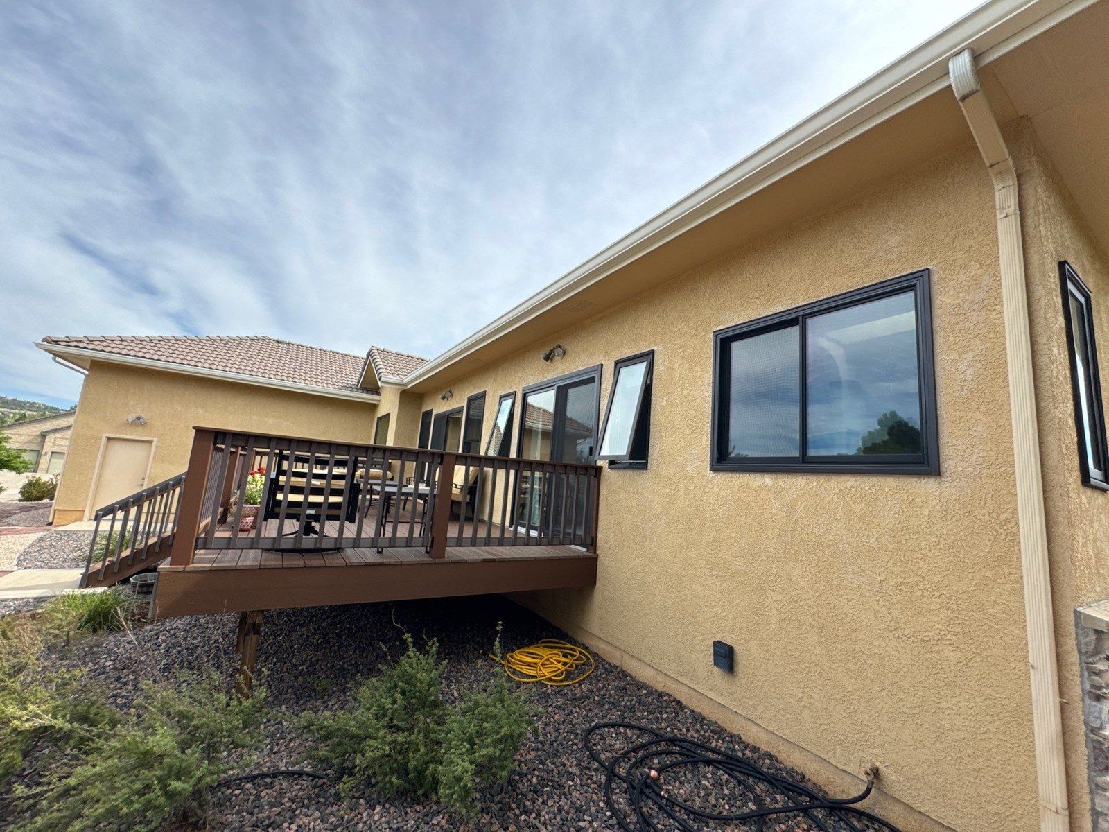 Existing rear stucco wall, windows and elevated deck at the same Colorado Springs property