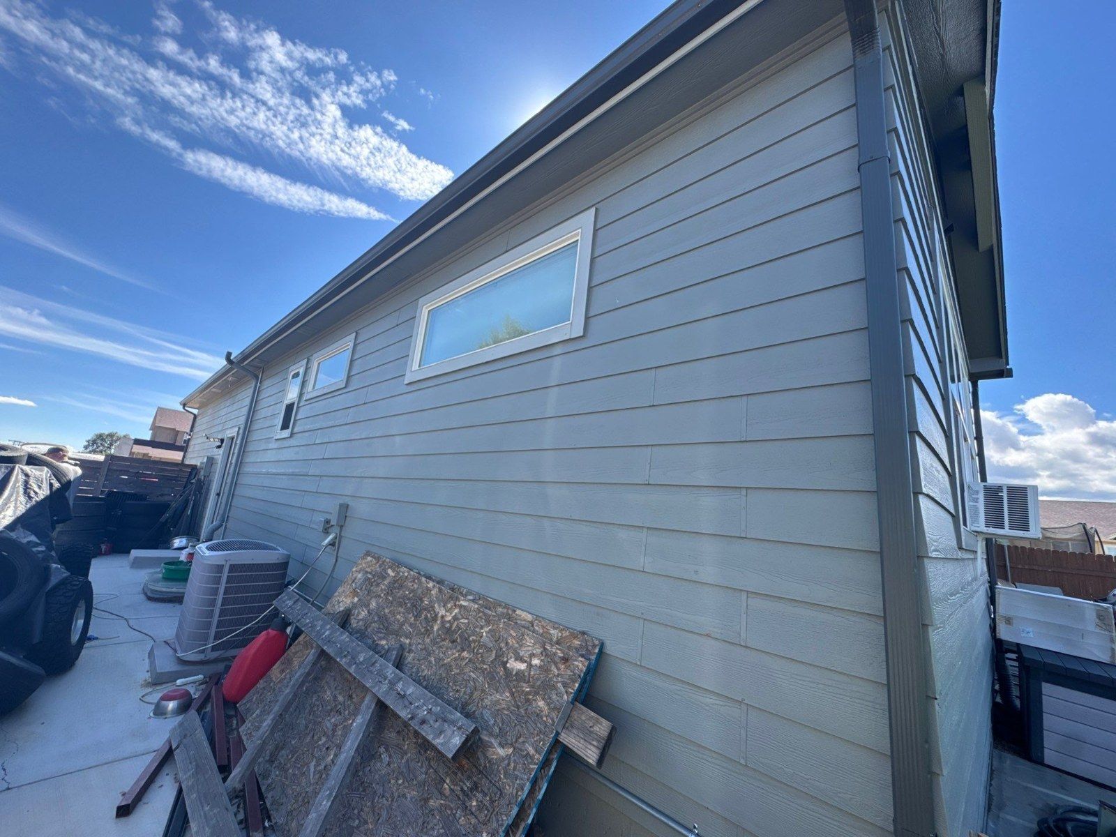 Existing lap siding, windows, roof edge and retained masonry in the Fountain exterior estimate