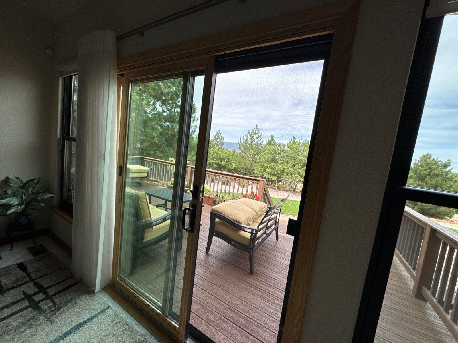 Interior view of the deck doors and surrounding wood trim at the Colorado Springs home in this estimate