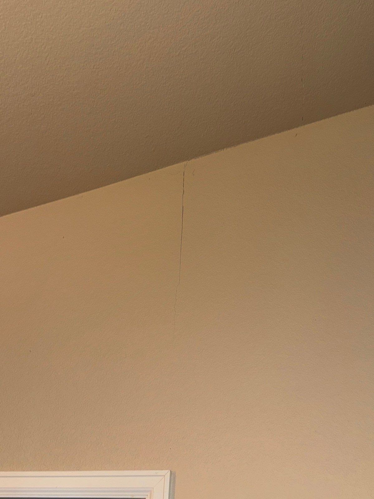 Vertical wall crack above an interior doorway in the same Colorado Springs estimate