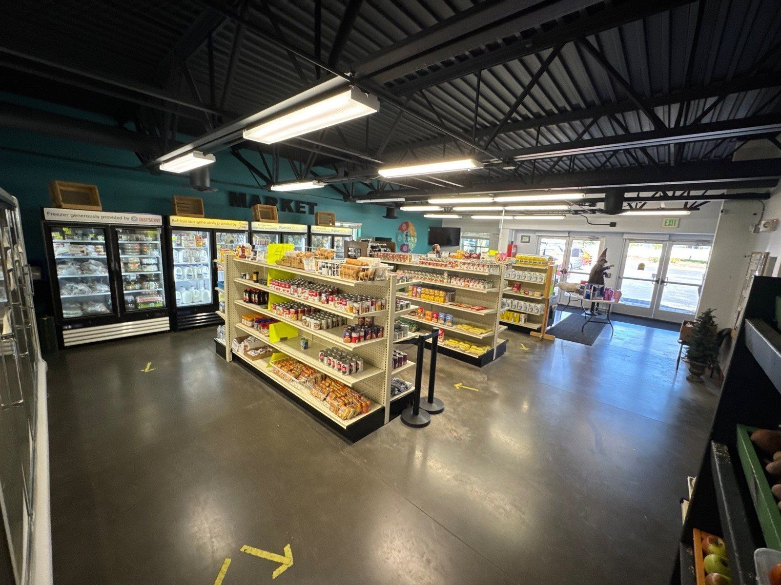 Existing commercial interior floor around stocked shelving in the same Monument epoxy estimate