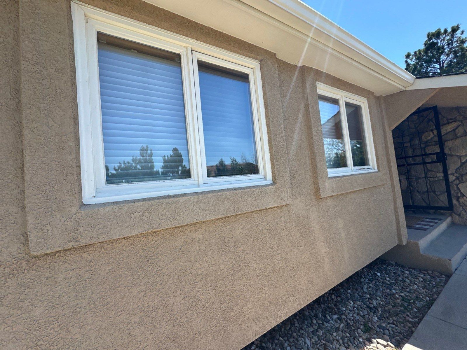 Closer view of the existing stucco texture and raised border around a Monument window