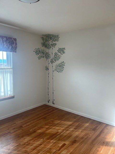 Existing decorative tree mural on a bedroom wall in a Pueblo West interior painting estimate
