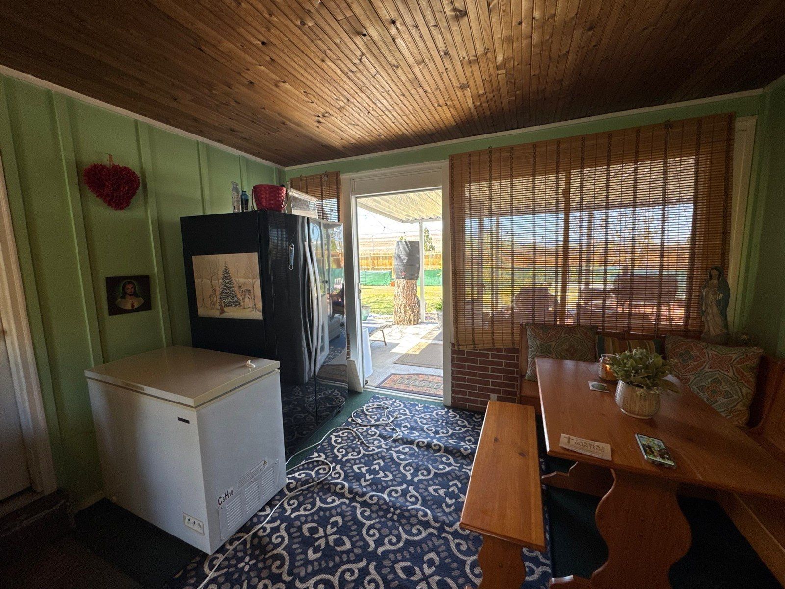 Existing paneled room with a stained wood ceiling, windows, furnishings and wall surfaces in the same Carroll estimate
