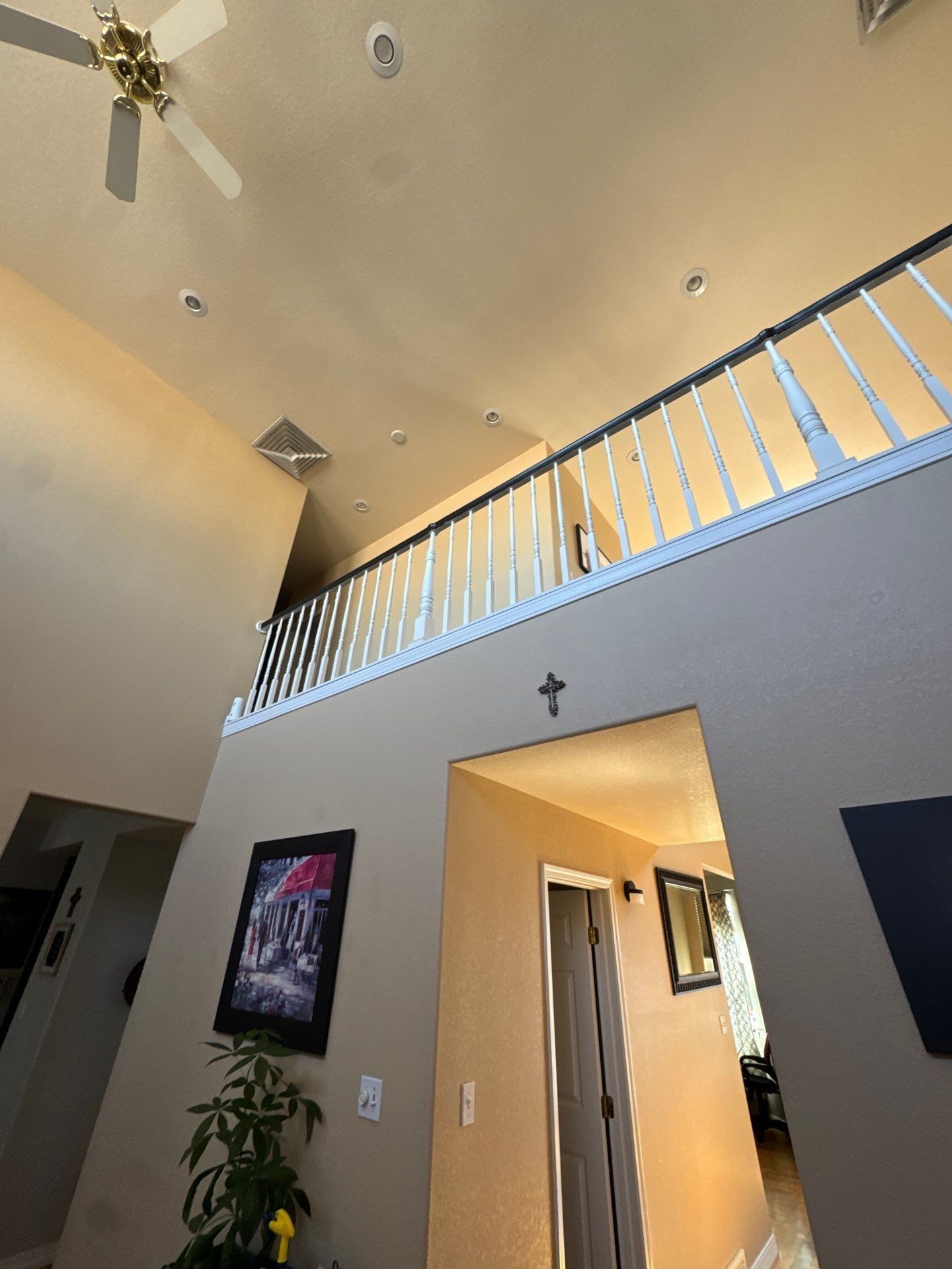 Tall walls ceiling and upper loft railing in the Pueblo interior painting estimate