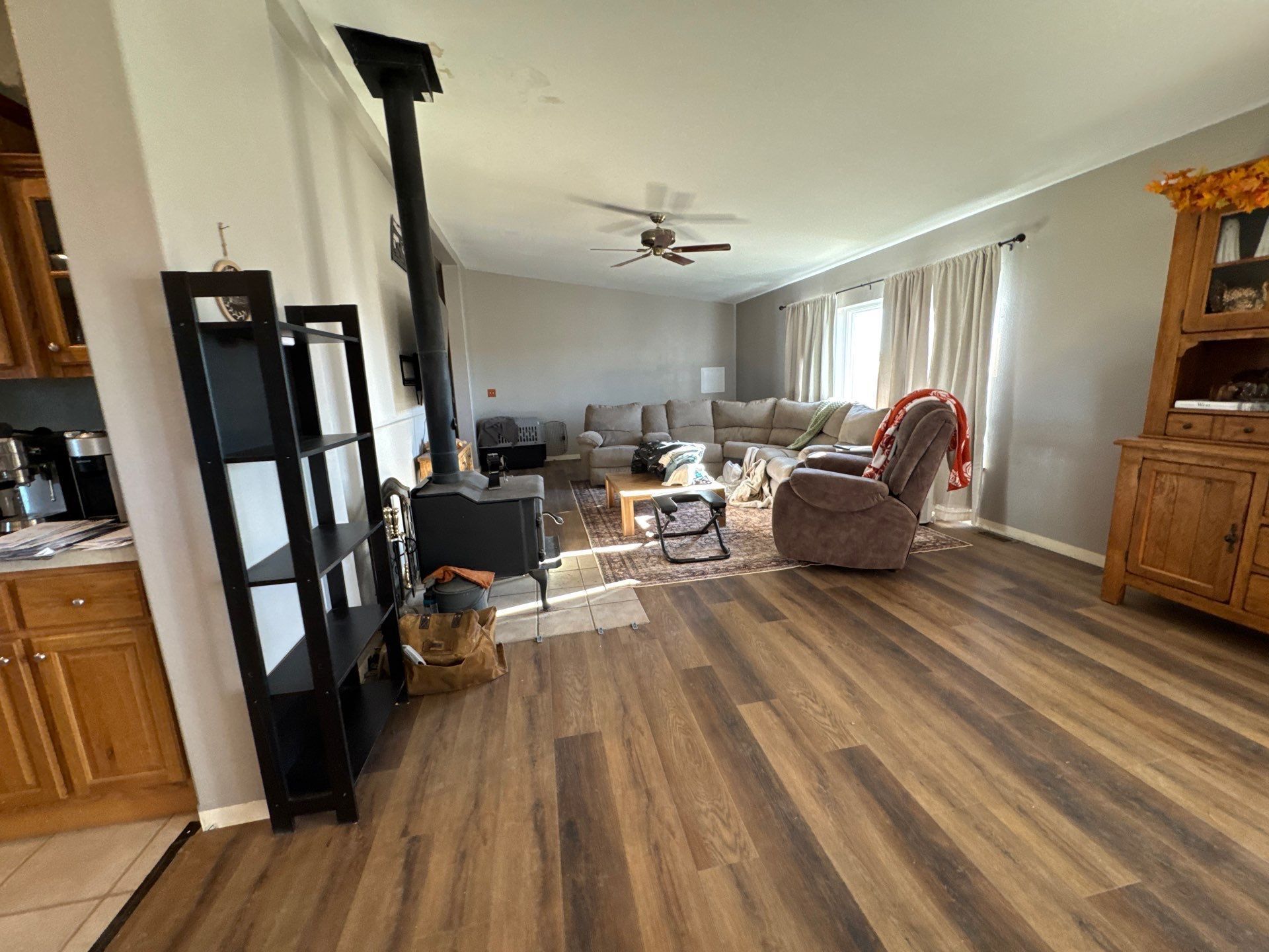Existing connected living and dining area in the Simla estimate with optional new baseboards