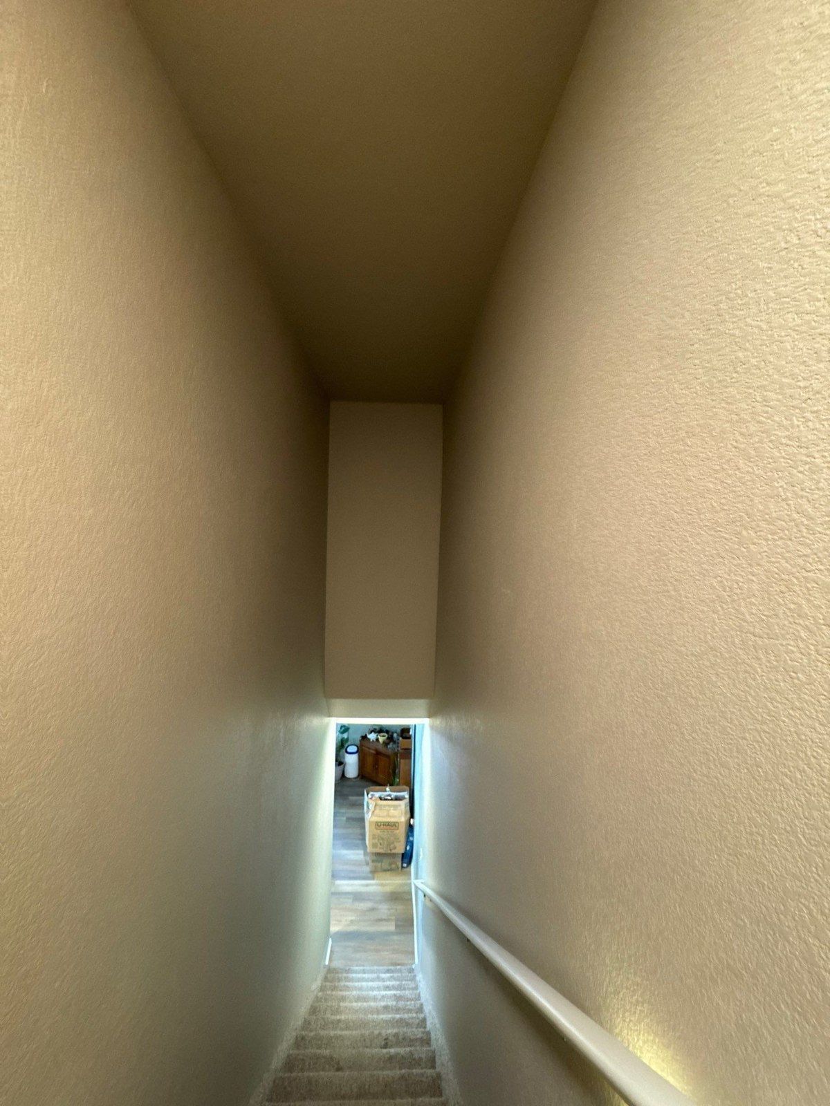Narrow interior stairwell with walls, ceiling and retained handrail in the same estimate