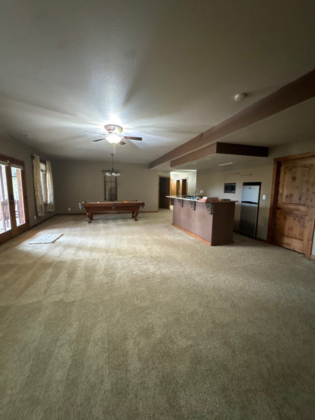 Open living room with broad wall and ceiling areas in the Woodland Park home