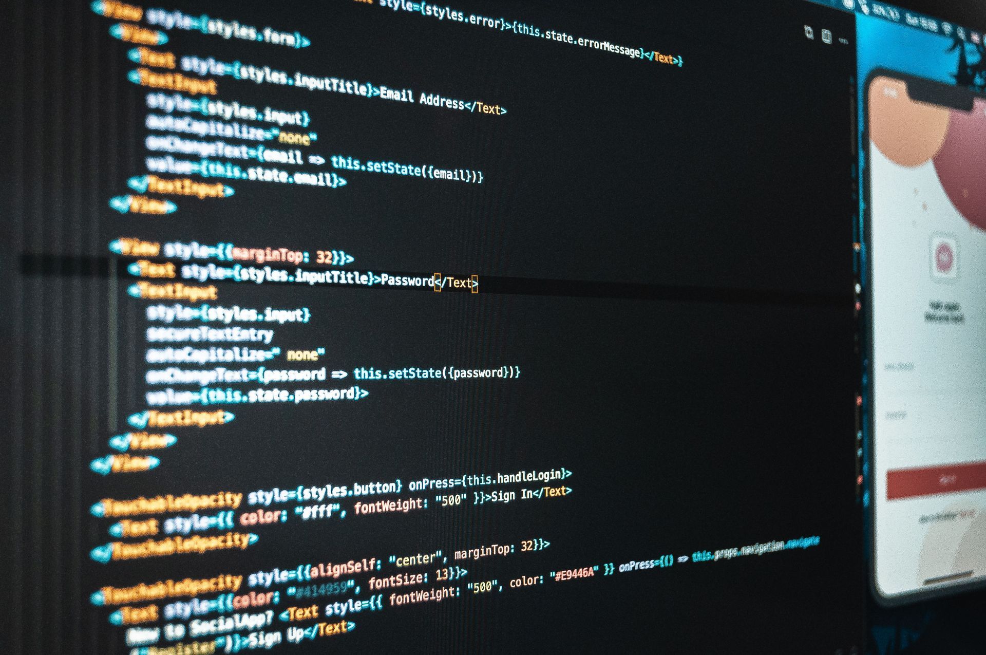 Person working at a desk with dual monitors in a modern office, coding on one screen and dashboard on the other