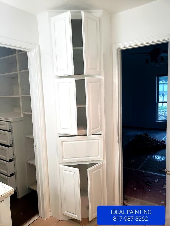 Tall white pantry cabinets in a kitchen hallway, with open doorways on either side.