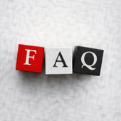 Colored blocks spelling “FAQ” on a white textured surface.