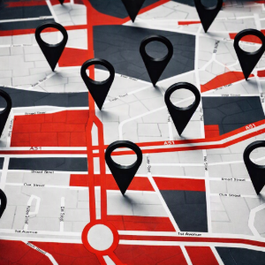 Stylized city map with multiple black location pins and red highlighted routes