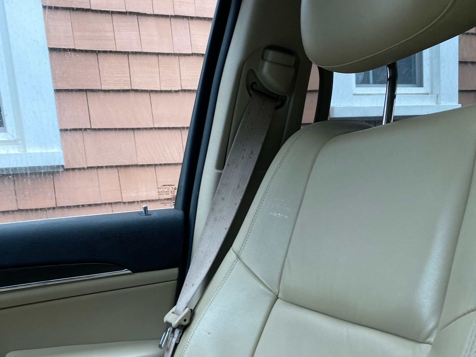 A car seat with a headrest and a seat belt