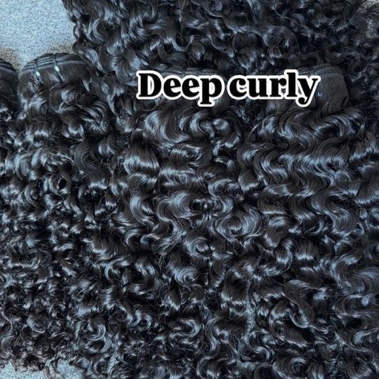 A close-up view of dark, tightly coiled deep curly hair extensions with text overlay reading 