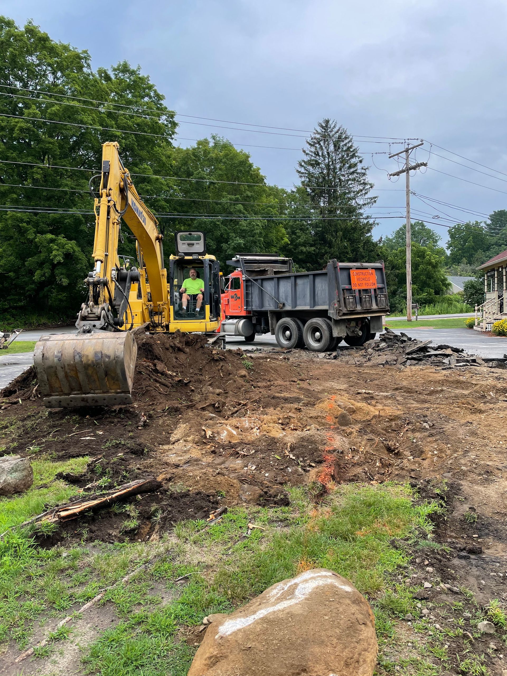 A construction site with a dump truck and an excavator
