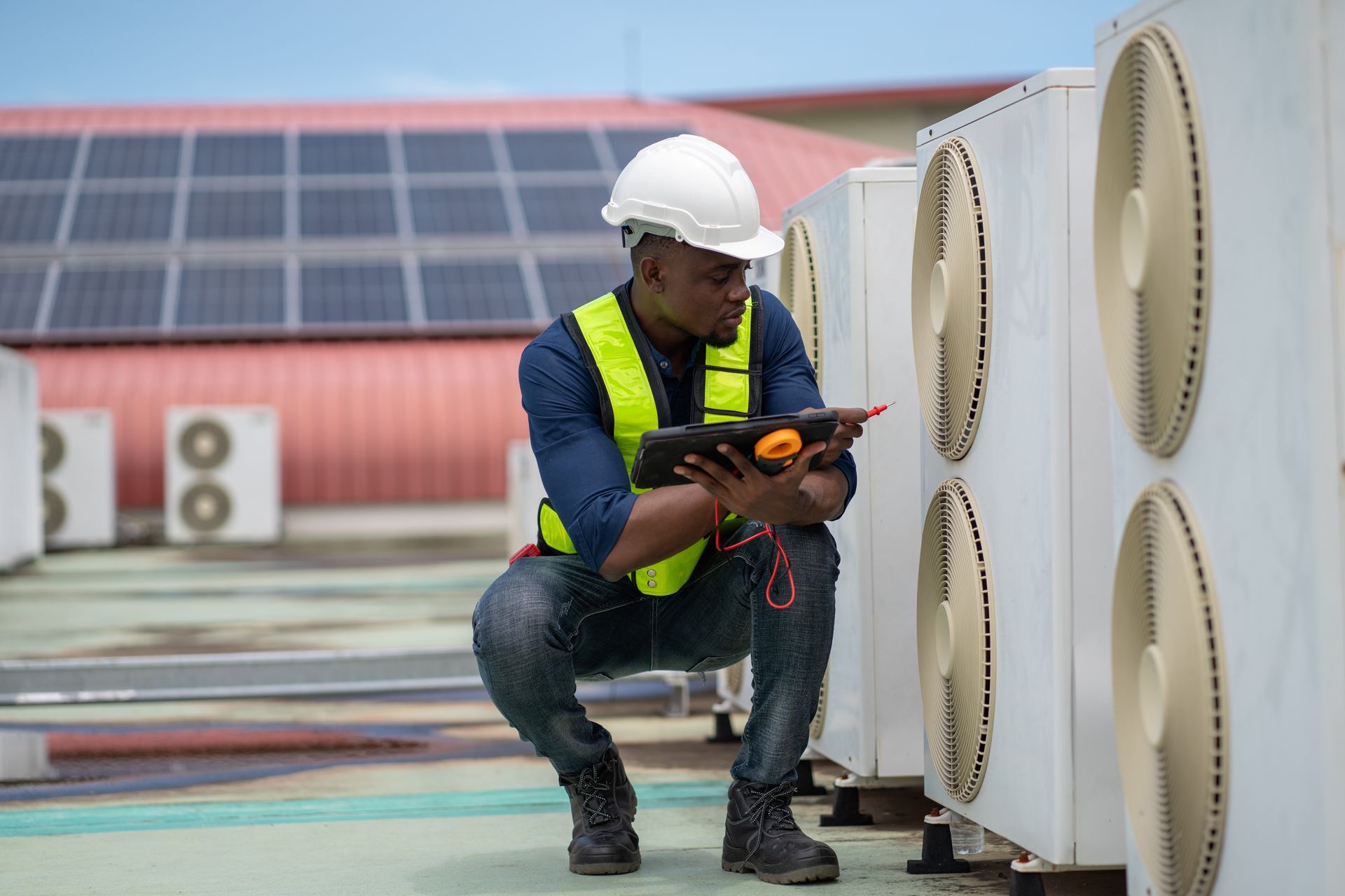 technician looking at industrial hvac system