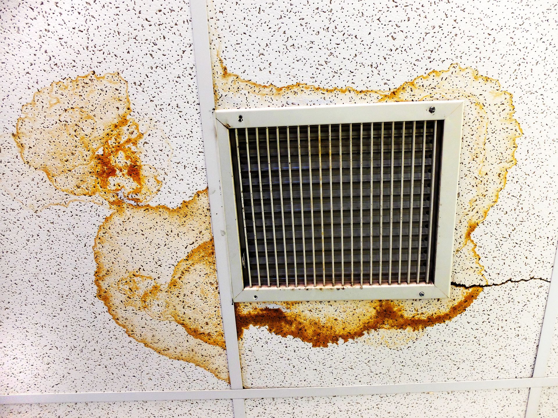 water damaged roof near AC vent
