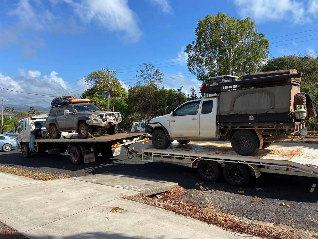 Two Trucks Are Sitting on Top of a Flatbed Truck — Cape York Towing & Transport in Townsville, QLD