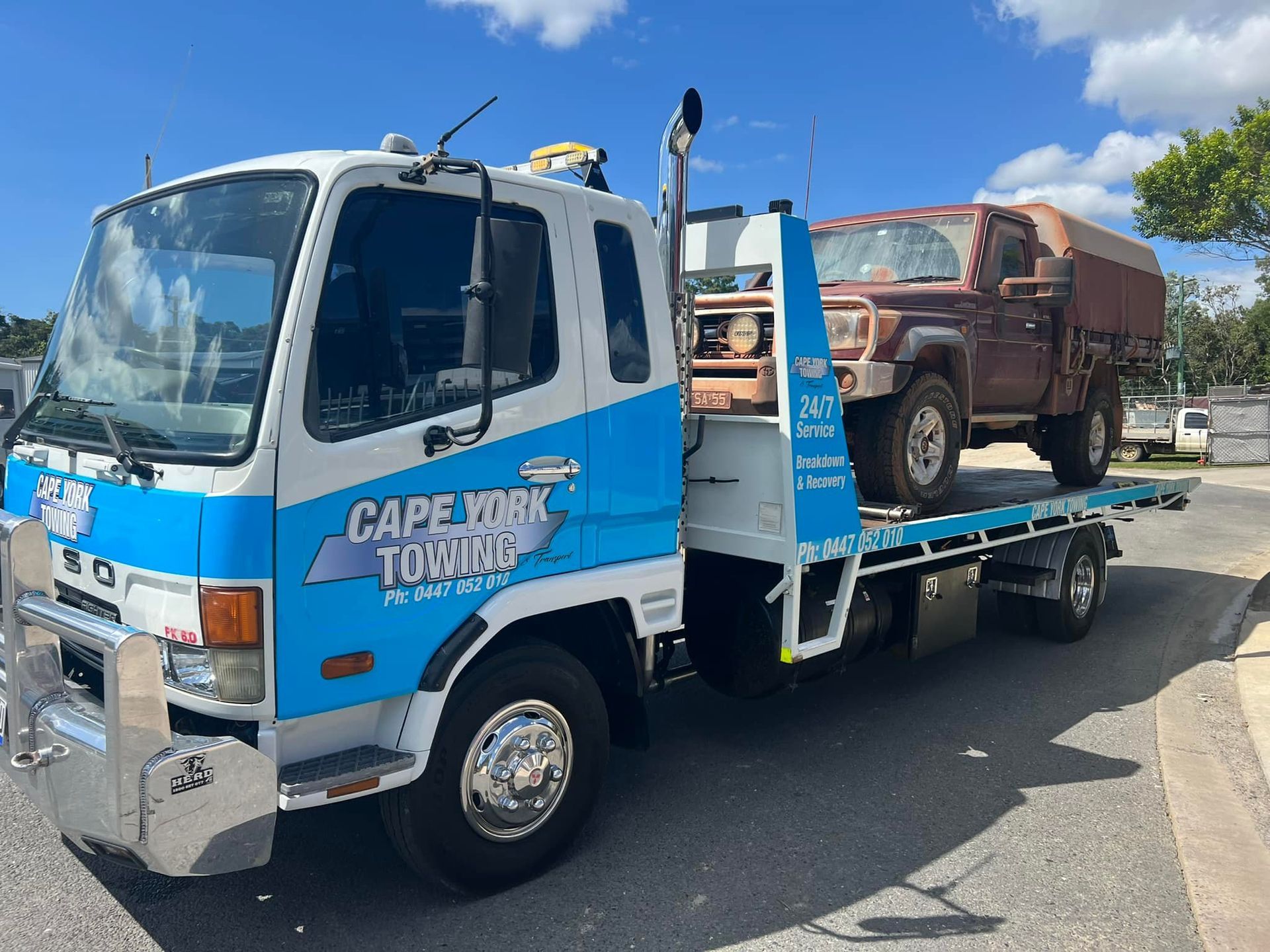 An Orange Car is Being Towed by a Tow Truck — Cape York Towing in Hann River, QLD