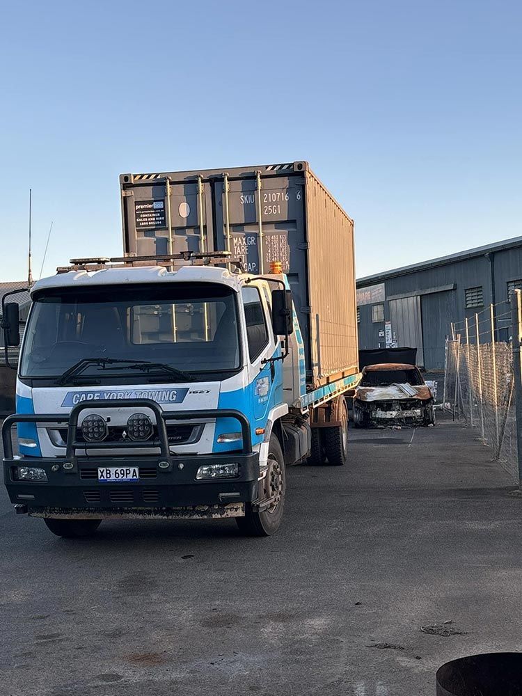 A Blue Truck With a Container on the Back is Parked in a Parking Lot — Cape York Towing & Transport in Musgrave, QLD