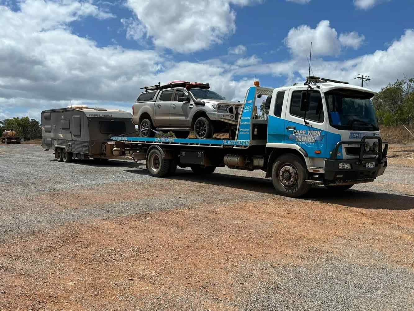 A Tow Truck is Carrying a Camper and a Truck — Cape York Towing in Rockhampton, QLD