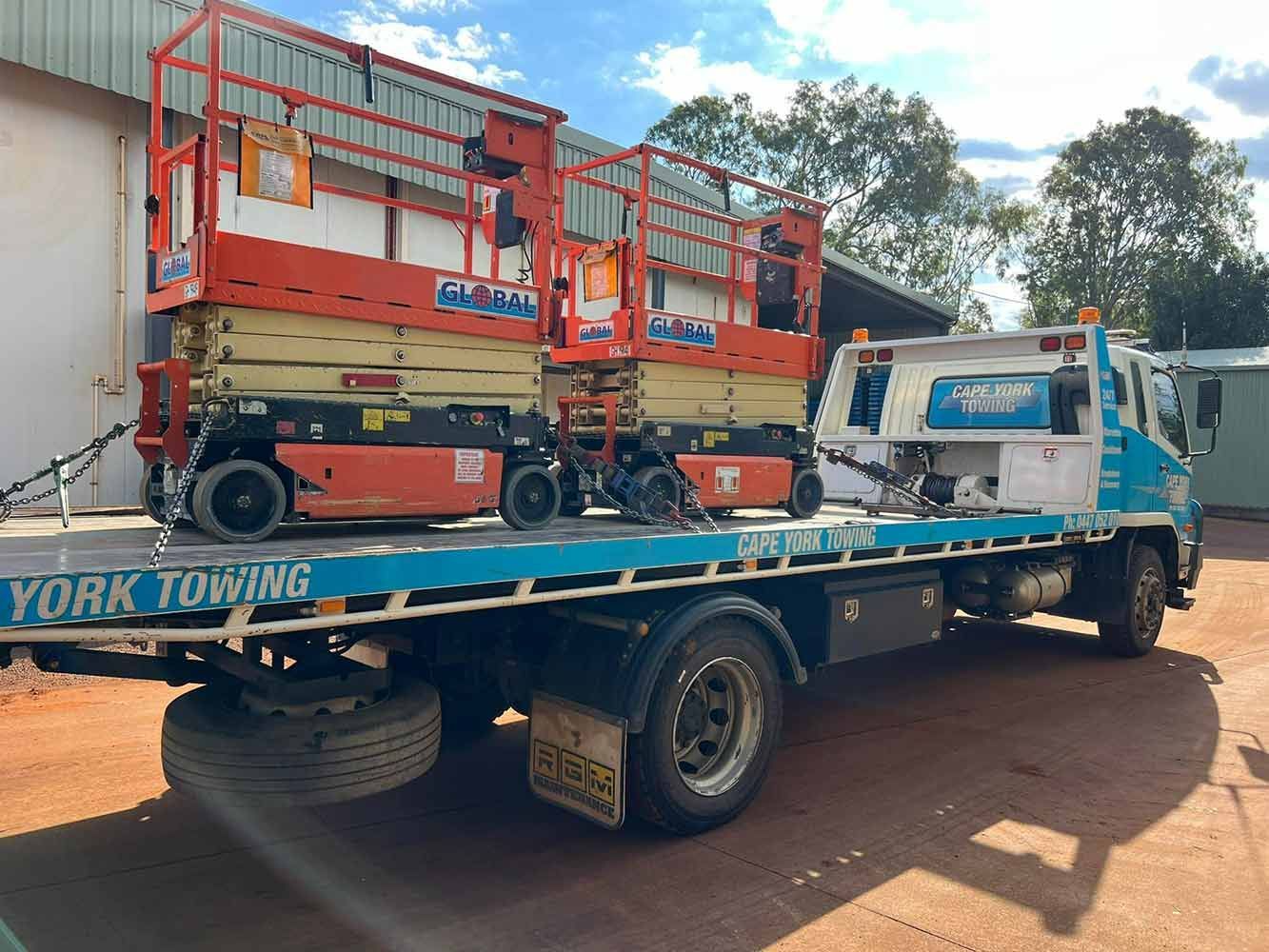 Two Scissor Lifts Are Sitting on Top of a Tow Truck — Cape York Towing & Transport in Sydney, NSW