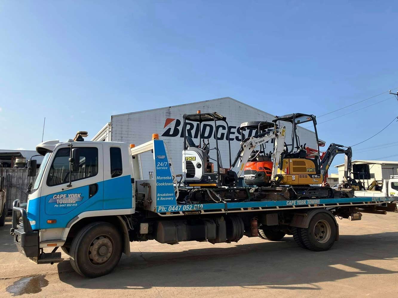 A Tow Truck is Parked in Front of a Bridgestone Building — Cape York Towing in Tablelands, QLD