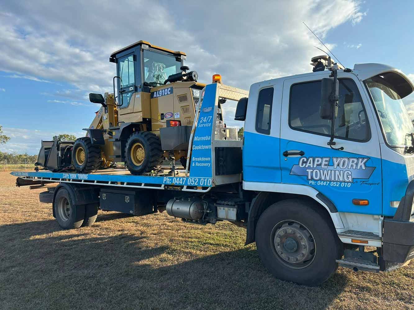 A Tow Truck With a Bulldozer on the Back of It — Cape York Towing & Transport in Georgetown, QLD
