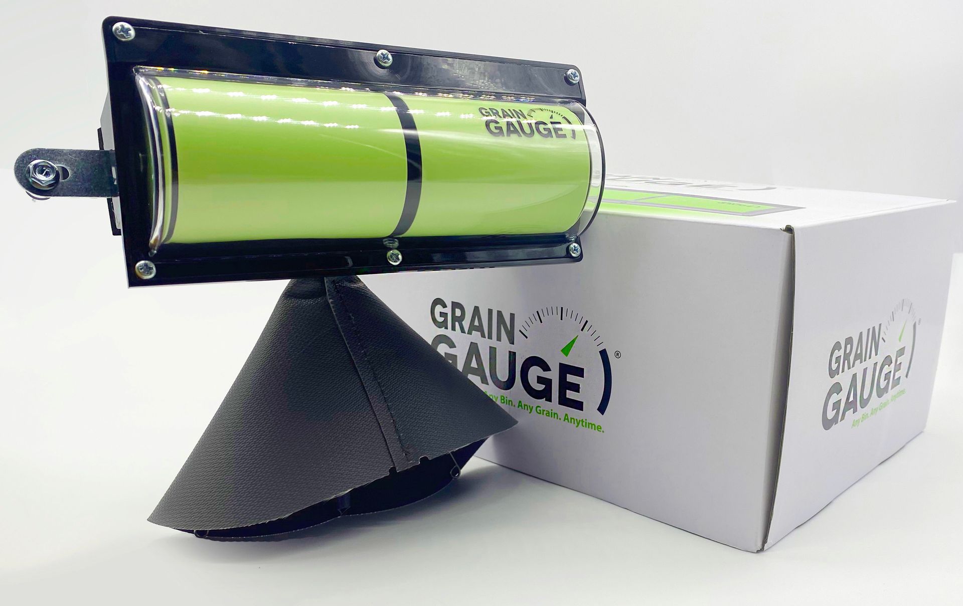 Green cylindrical device mounted on a white box with a black funnel underneath and “GRAIN GAUGE” text.