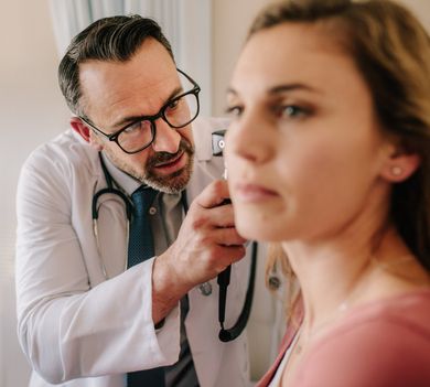 audiologist checking on patient ear