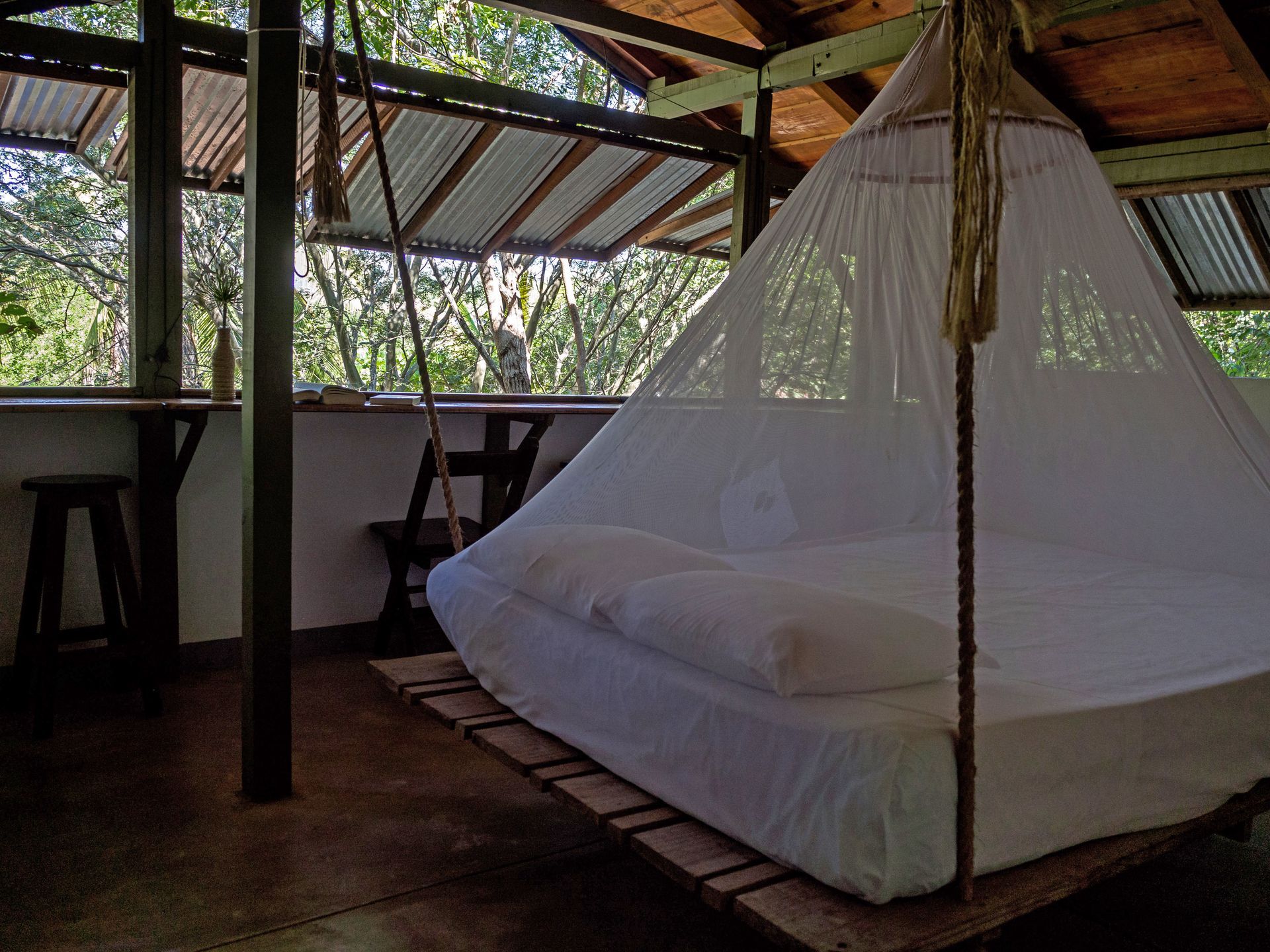 Dormitorio en una cabaña al aire libre con vistas a un bosque en posada del arquitecto en mazunte, oaxaca