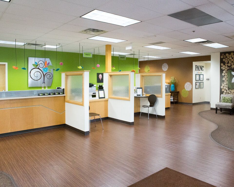 A large room with a wooden floor and a green wall.