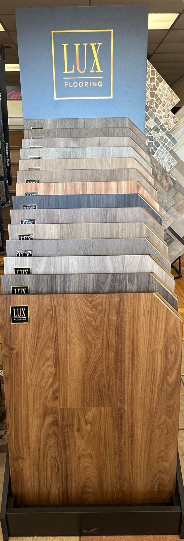 Stacked wooden samples with a blue “LUX” sign at the top.