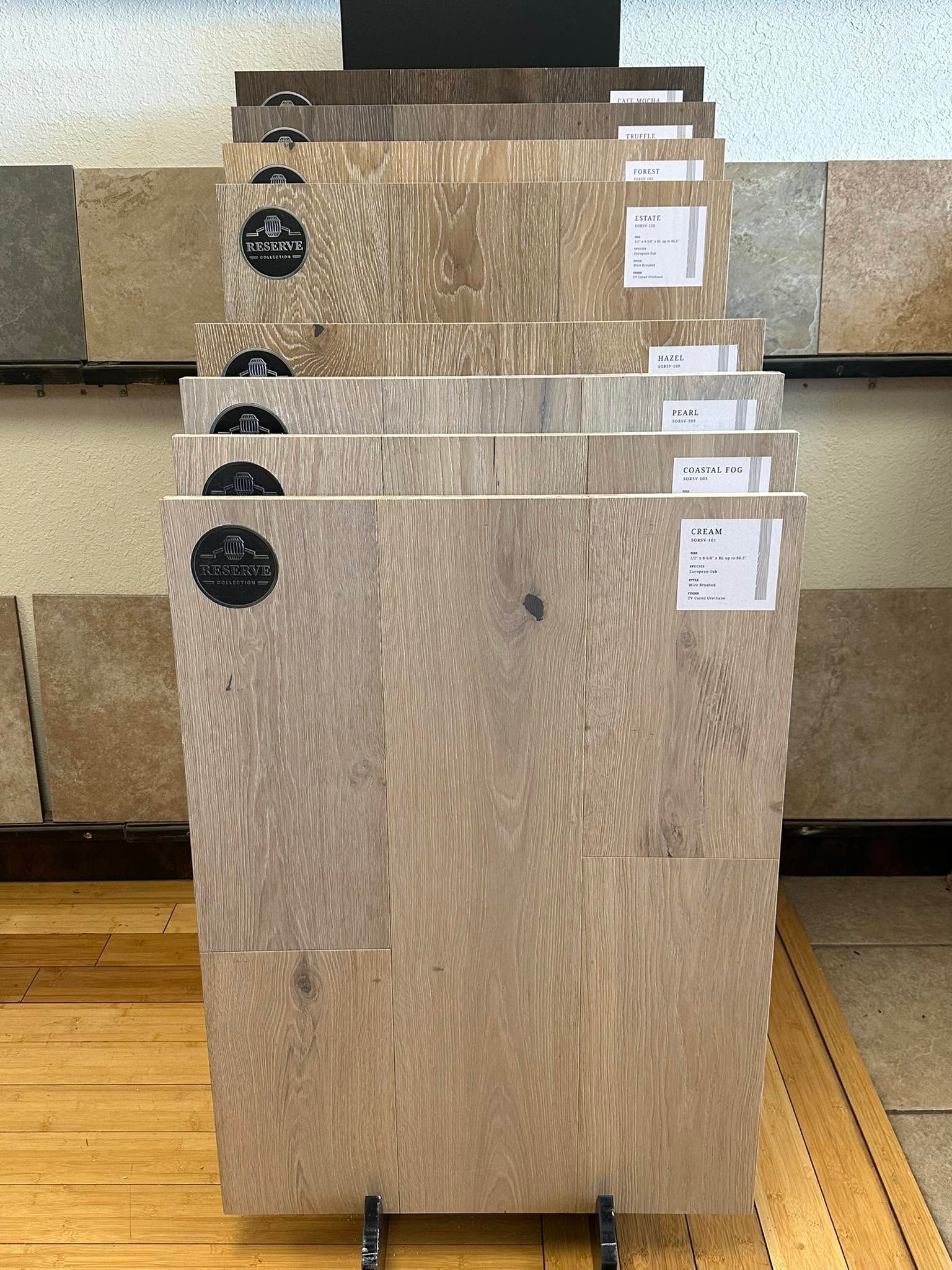 Stack of large beige stone slabs with labels, leaning on a rack in a warehouse or showroom.